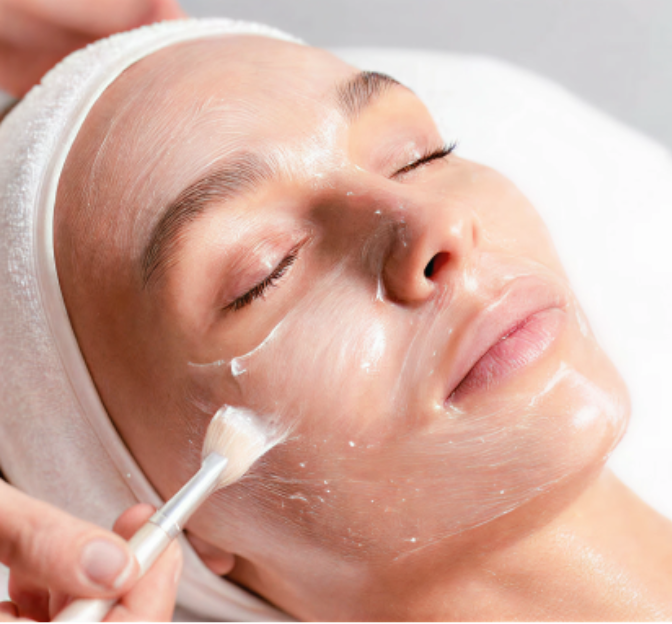 Person receiving a facial treatment with a white towel on their head