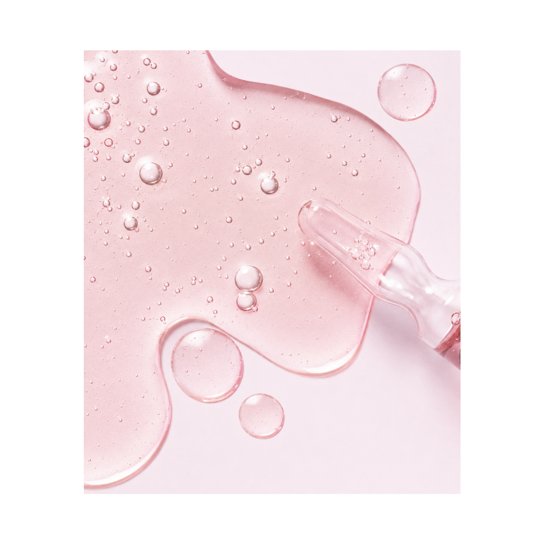 Pink skincare product with ampoule on a pink background