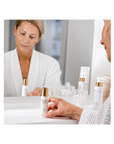 Woman holding JANSSEN COSMETICS Instant Lift Serum for mature skin