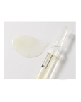 Texture of Janssen Cosmetics Couperose Fluid Ampoules on a white background.